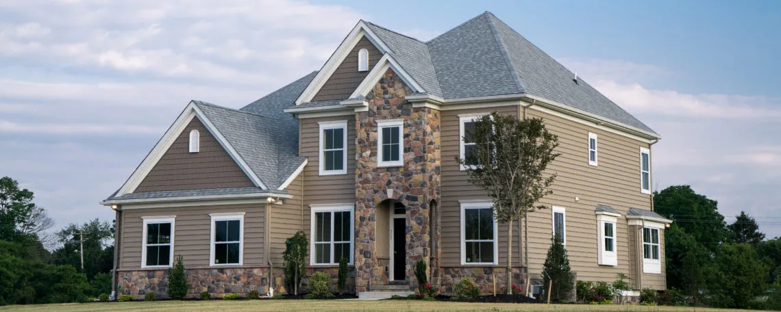 A home with a large front yard and a large back yard.